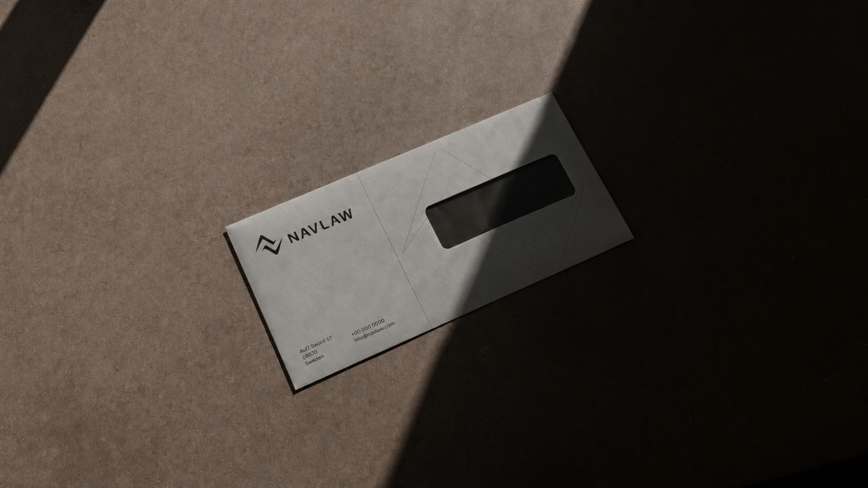 NAVLAW branded window envelope in warm grey stock on kraft paper background — NAVLAW combination mark printed in dark ink, address block showing Au17 Sword ST, 08970, Sweden, window aperture for interior document address showing
